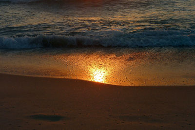 Scenic view of beach at sunset