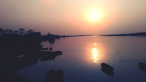 Scenic view of lake against romantic sky at sunset