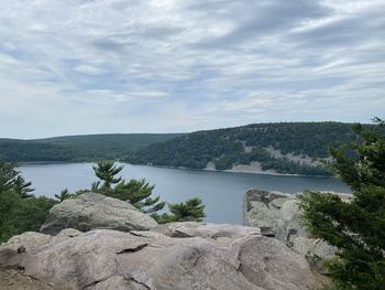 Scenic view of sea and mountains against sky