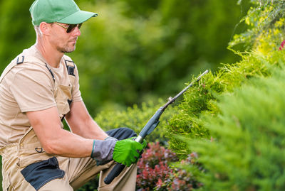 Gardener using pruning sheers at yard
