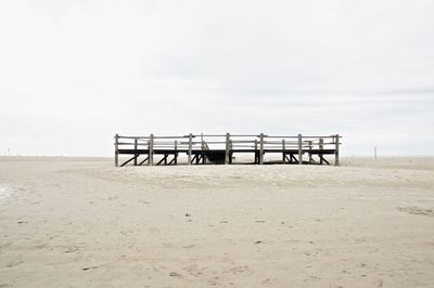 Lifeguard hut on beach against sky