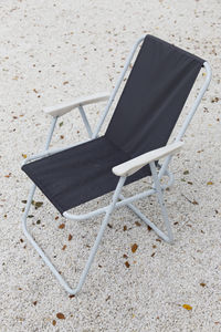 Beach chairs on stone background.