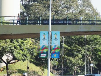 Low angle view of information sign on bridge