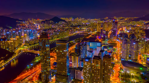 High angle view of illuminated city buildings at night