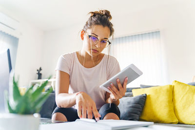 Woman using tablet at home