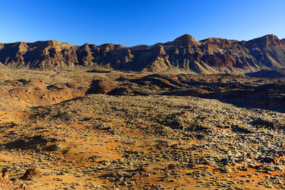 Rocky mountains at el teide national park against clear blue sky