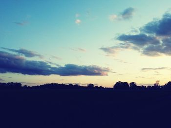 Silhouette of trees against sky at sunset