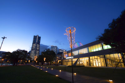 Low angle view of illuminated buildings against clear sky at night