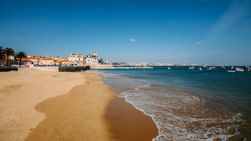 Scenic view of beach against sky in city