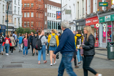 Group of people walking on city street