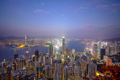 High angle view of illuminated city against sky at night