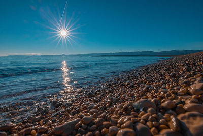 Scenic view of sea against clear blue sky