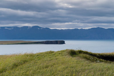 Scenic view of lake and mountains against sky