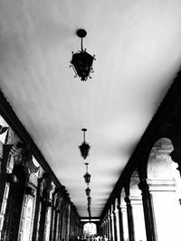 Low angle view of illuminated chandelier hanging on street amidst buildings