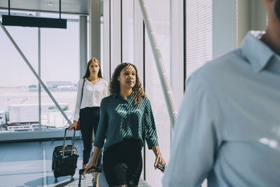 Row of multi-ethnic business colleagues walking in corridor at airport