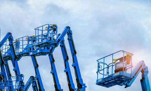 Low angle view of articulated boom lift against sky. aerial platform lift. telescopic boom lift.