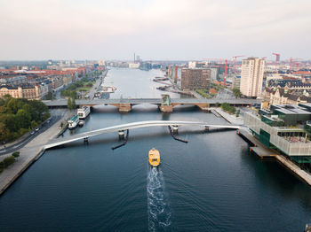 High angle view of city by sea against sky