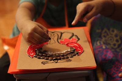 Midsection of boy making artwork at home