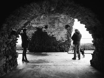 Man and woman standing in cave
