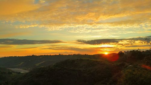 Scenic view of landscape against sky during sunset