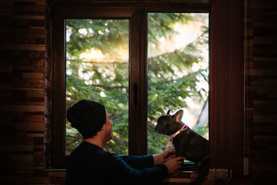 Man and french bulldog dog at home