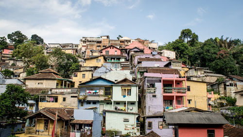 Buildings in town against sky