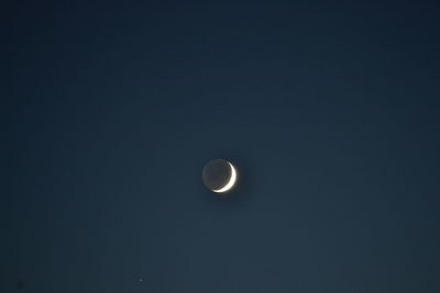 Low angle view of moon against sky at night