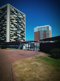 Buildings against clear blue sky