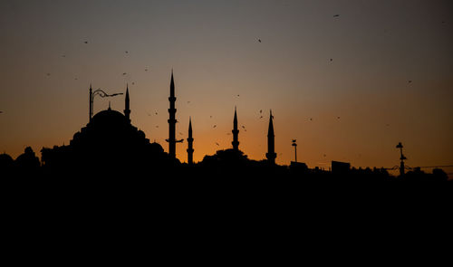 Silhouette of temple building against sky during sunset