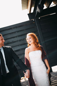 Low angle view of a smiling young woman