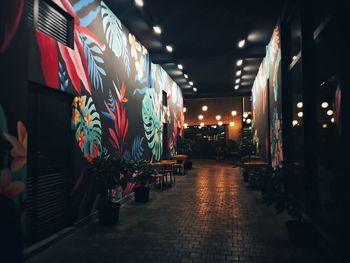 Illuminated lanterns hanging on footpath at night