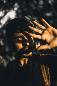 Close-up of young man looking away in forest