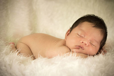 Cute baby boy sleeping on fur