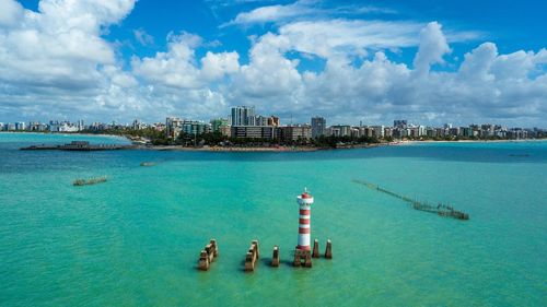 Panoramic view of sea and buildings against sky