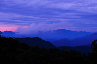 Scenic view of silhouette mountains against sky at sunset