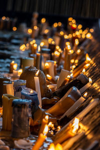 Close-up of lit candles in temple