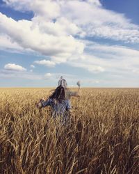 Hay bales on field against sky