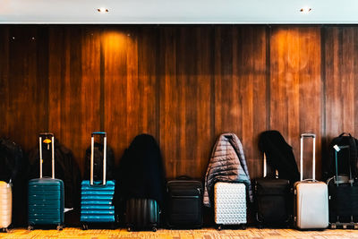 View of suitcases arranged by wall