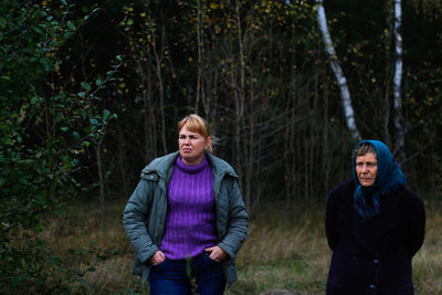 Full length of a two women standing in forest