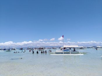 People on beach against sky