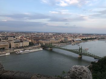 High angle view of river amidst buildings against sky