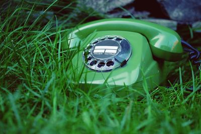 Vintage green telephone on grass