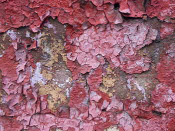 Background of old colorful peeling paint wall. pattern of rustic grunge material