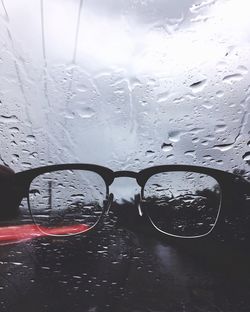 Close-up of wet car window during rainy season