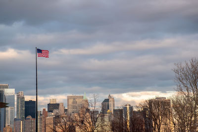 Flag amidst buildings against sky in city