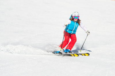 Full length of woman skiing on snow