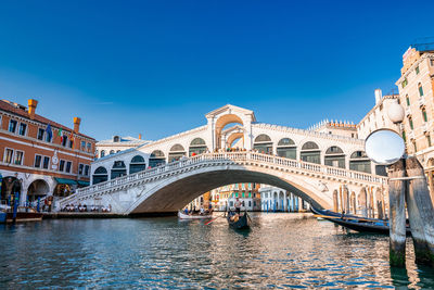 Traditional gondola near world famous canal grande and rialto bridge