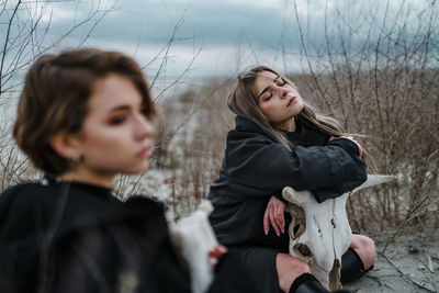 Young woman lying on field