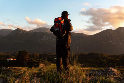 Man standing on mountain against sky