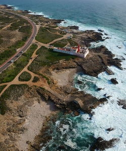 Aerial view of lighthouse by coastline